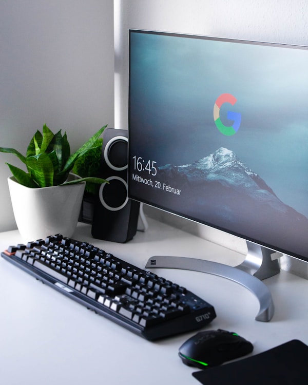 A computer screen on a desk.